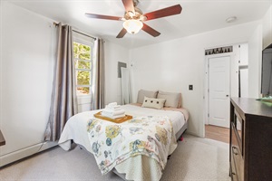 Queen bed with amazing windows and towel decoration