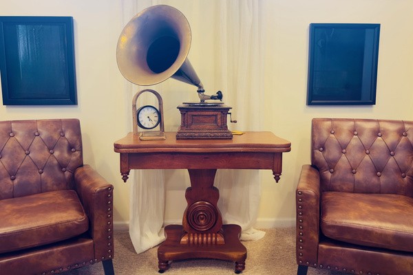 Library seating beside the vintage record player and stocked bookshelves.