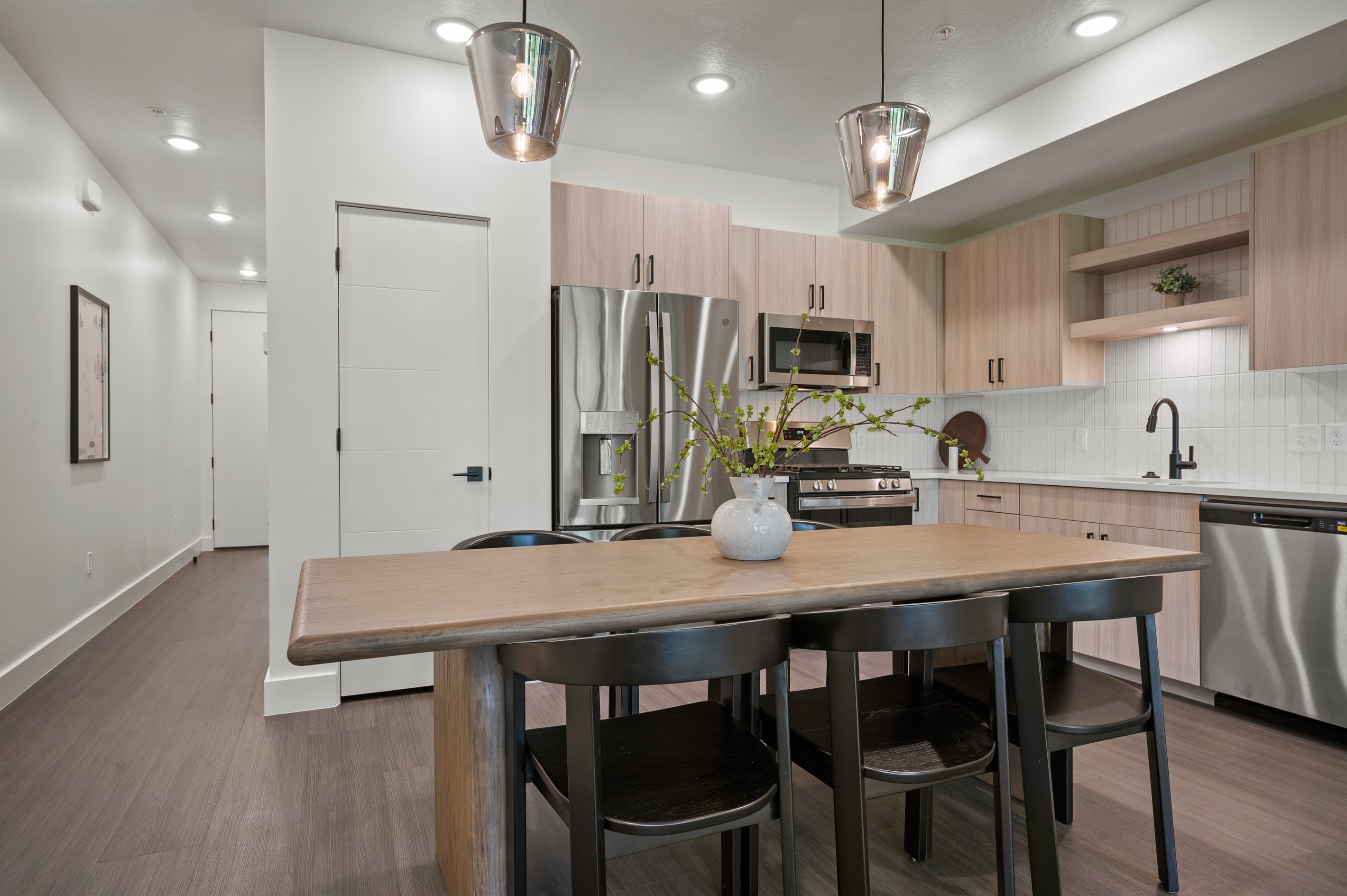 Quartz countertops and modern lighting makes dinner prep enjoyable.