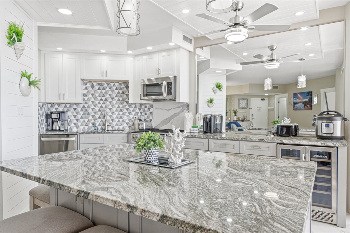 Most vacation rentals have a kitchen. This one has a showpiece. Exotic granite counters, custom white cabinetry, a full appliance suite, and finishes that belong in a luxury home magazine.