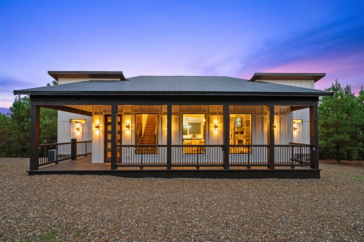 Evening glow of the front porch with inviting entry.