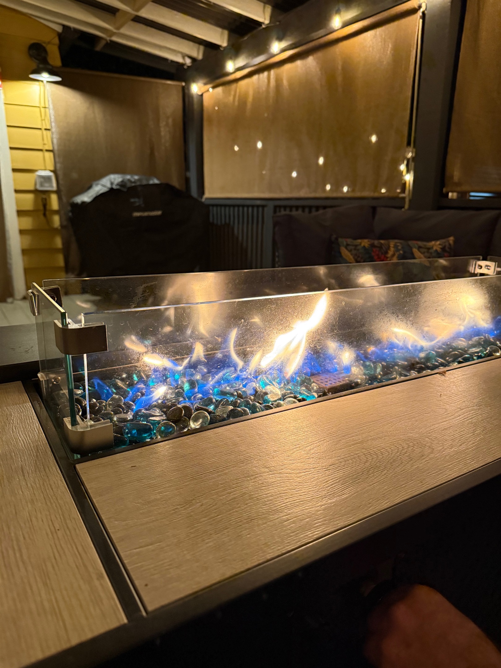 Propane firetable on covered side/back porch with cozy couch as well as gas grill