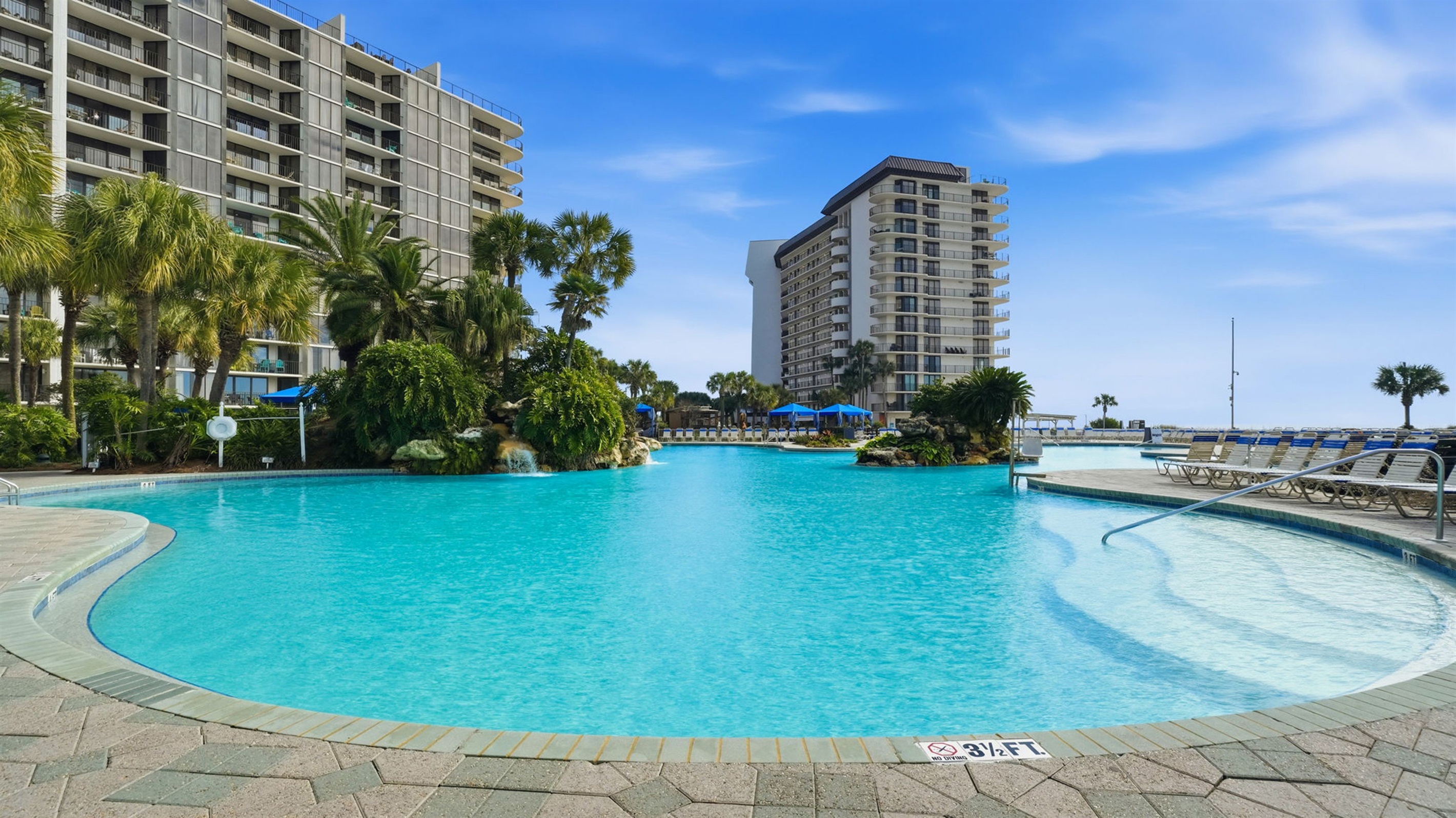 Edgewater's picturesque lagoon-style pool designed with true relaxation in mind with serene built-in waterfalls