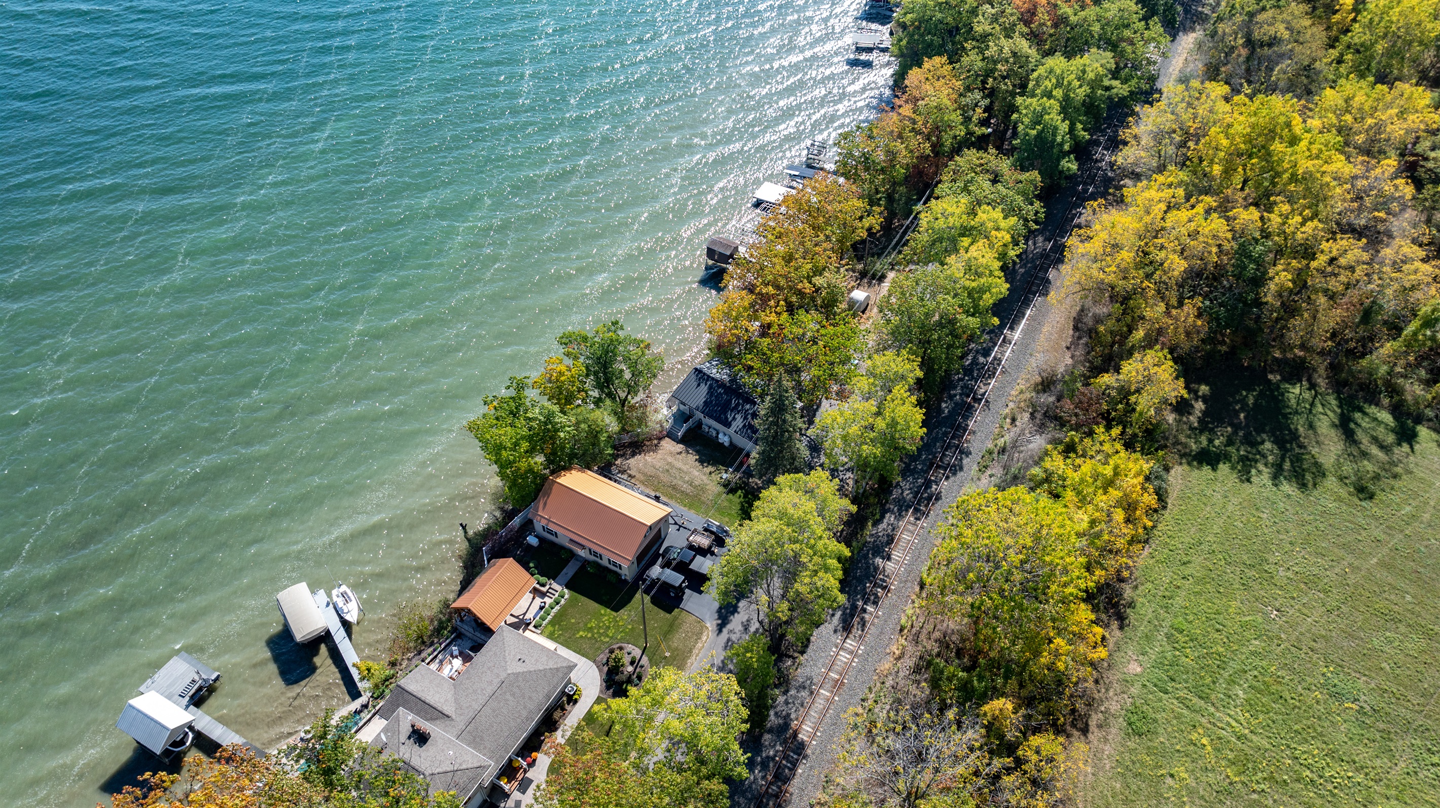 Beautiful lakefront property tucked among trees, offering both privacy and panoramic views.