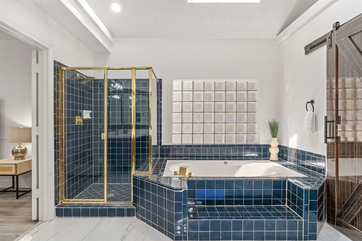 Soak or steam—this spa-style bathroom is all yours plus premium Ginger Lily Farm products.