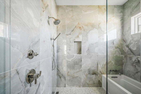 The primary bathroom features a wet room so you can take a shower and a bath without having to leave either.