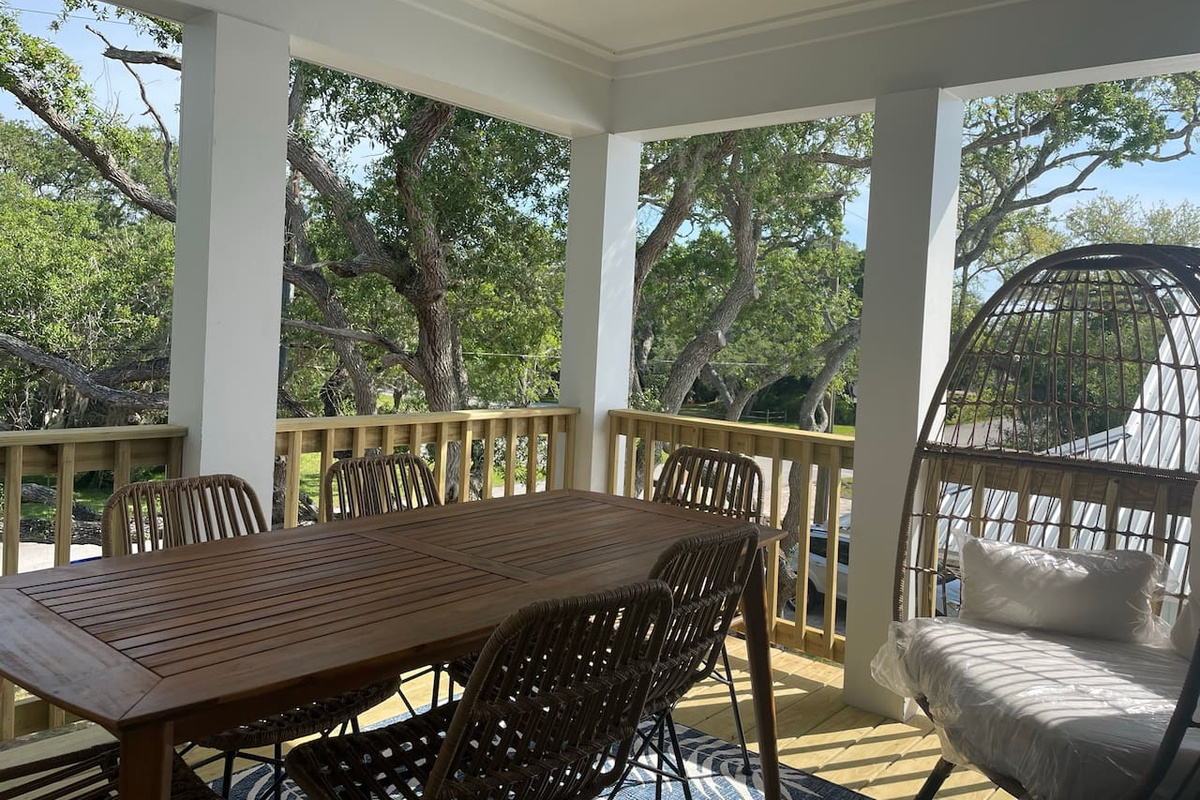 The egg chair is prime real estate at golden hour — tucked into the balcony's corner beneath the oaks, it's where paperbacks get finished, naps happen by accident, and afternoon plans get happily abandoned.