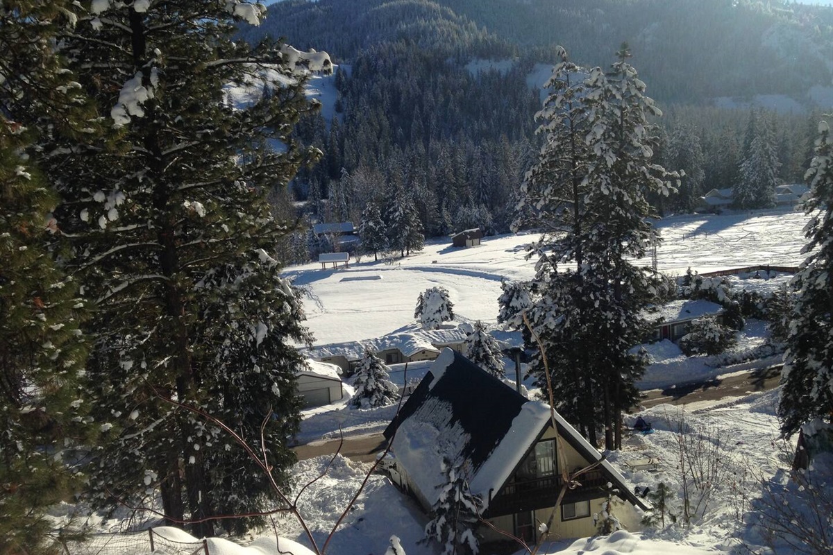 Winter wonderland views of the cabin and community pond.