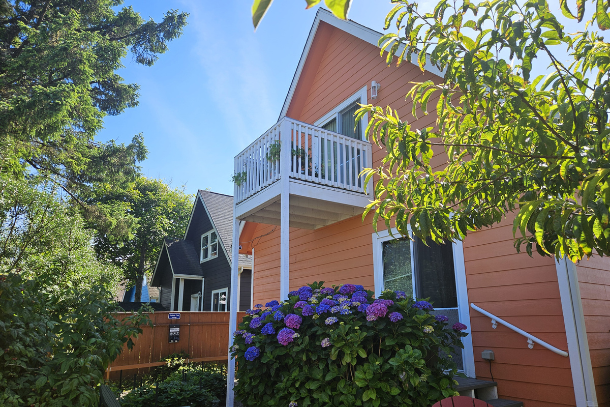 Luxurious coastal gardens adorn the back yard oasis where you can unwind between trips to the beach.