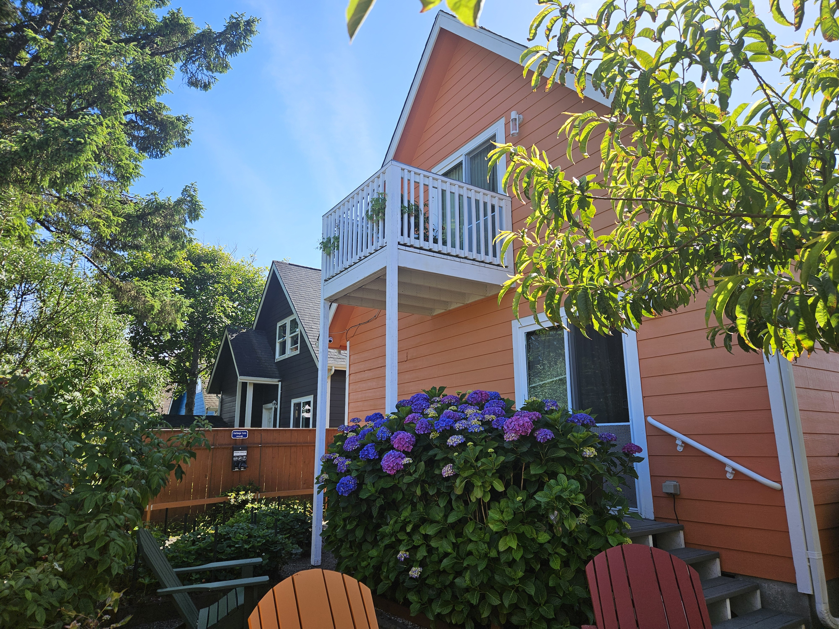 Luxurious coastal gardens adorn the back yard oasis where you can unwind between trips to the beach.