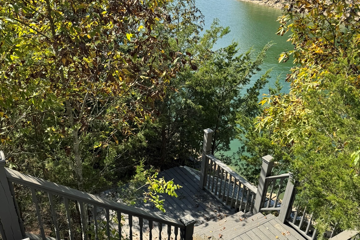 Stairway leading down to dock, firepit/seating area and rocky bluff