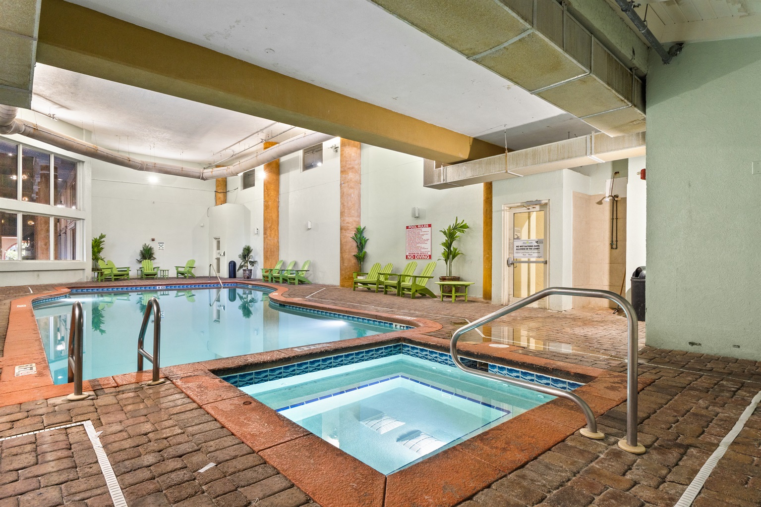 Indoor pool area also includes a jacuzzi with jets.