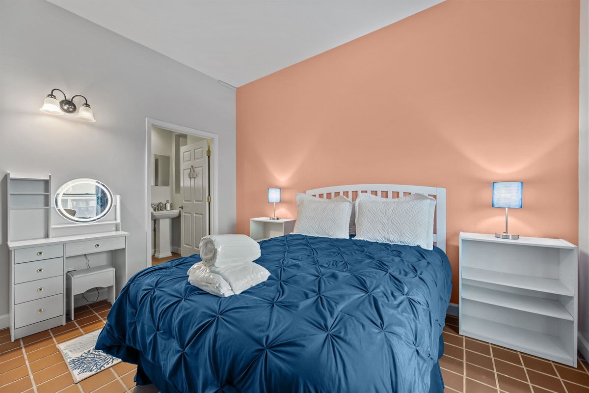 Bright and airy Master bedroom featuring step-free access, a private en-suite bath, and calming coastal tones for a comfortable night&rsquo;s rest