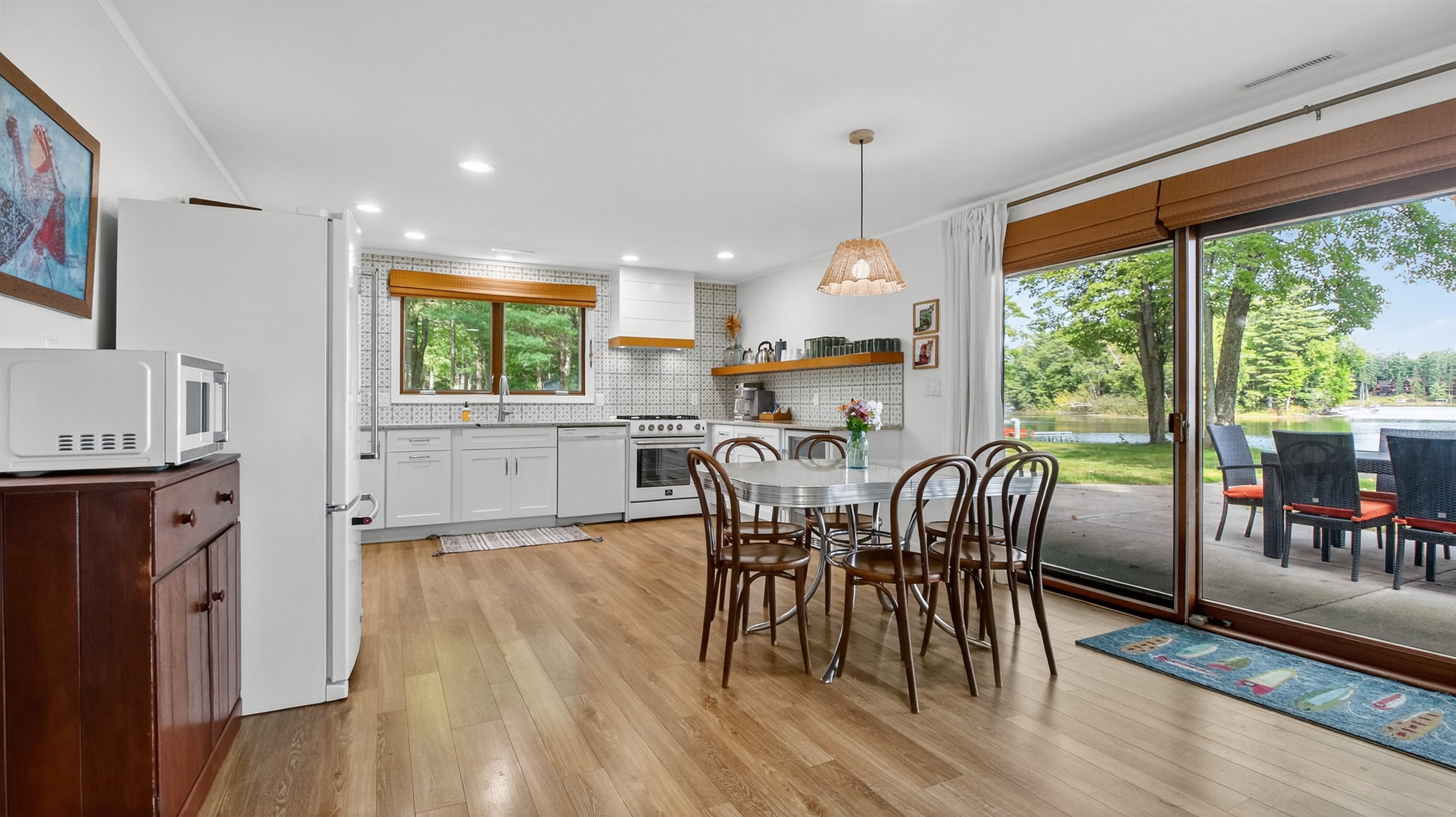 Cook with ease in the fully equipped kitchen - featuring modern appliances, plenty of counter space, and everything you need for preparing meals. The dining area seats everyone together for lakeside meals and game nights.