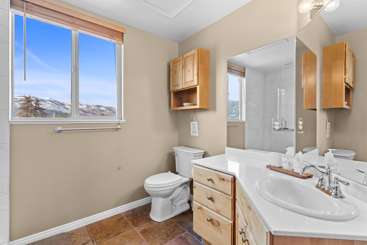 Large vanity with generous counter space for relaxed, unrushed mornings.