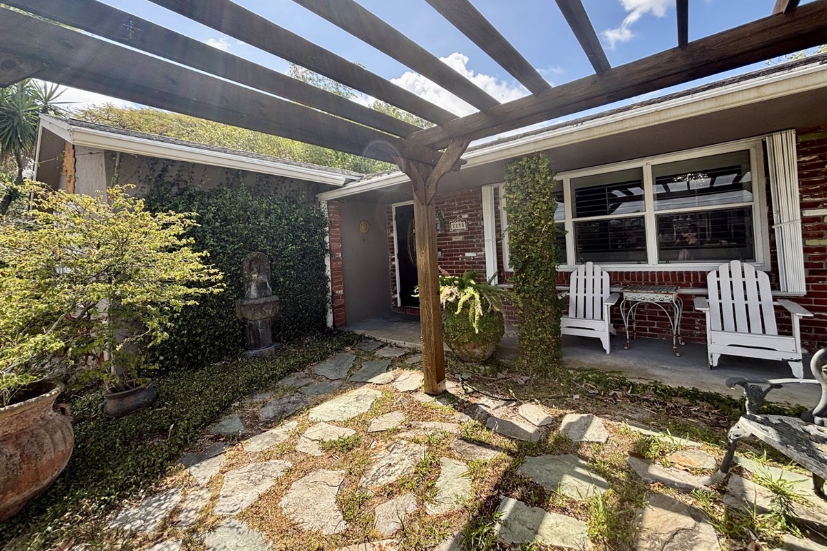 Enjoy time outside under the pergola, surrounded by a garden and fountains.