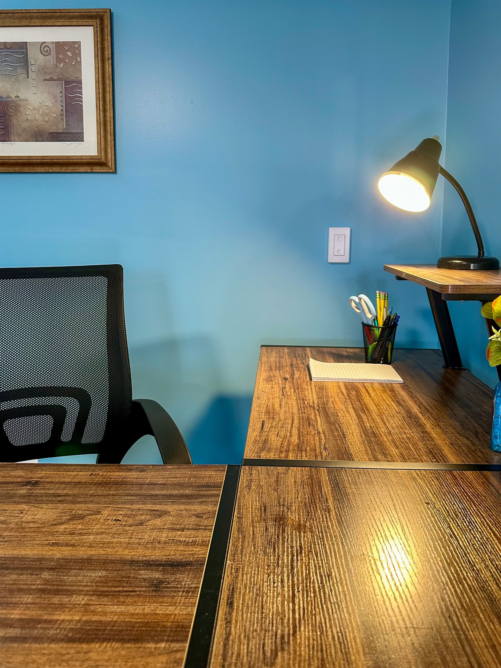 Workspace detail featuring a notepad and organizer stocked with pens, pencils, and scissors—thoughtfully provided for guest convenience, whether catching up on work or jotting down plans during your stay.