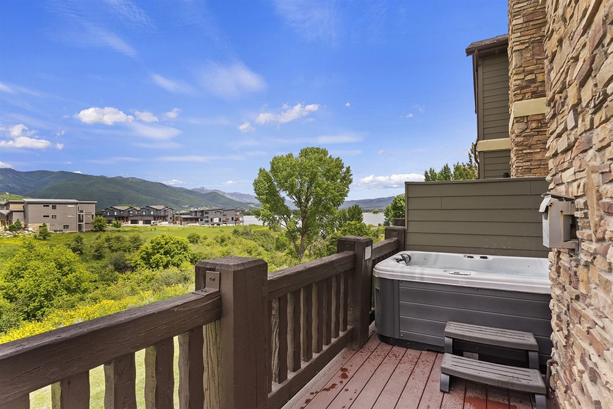 Private deck featuring a relaxing hot tub and stunning mountain views—the perfect spot to unwind.