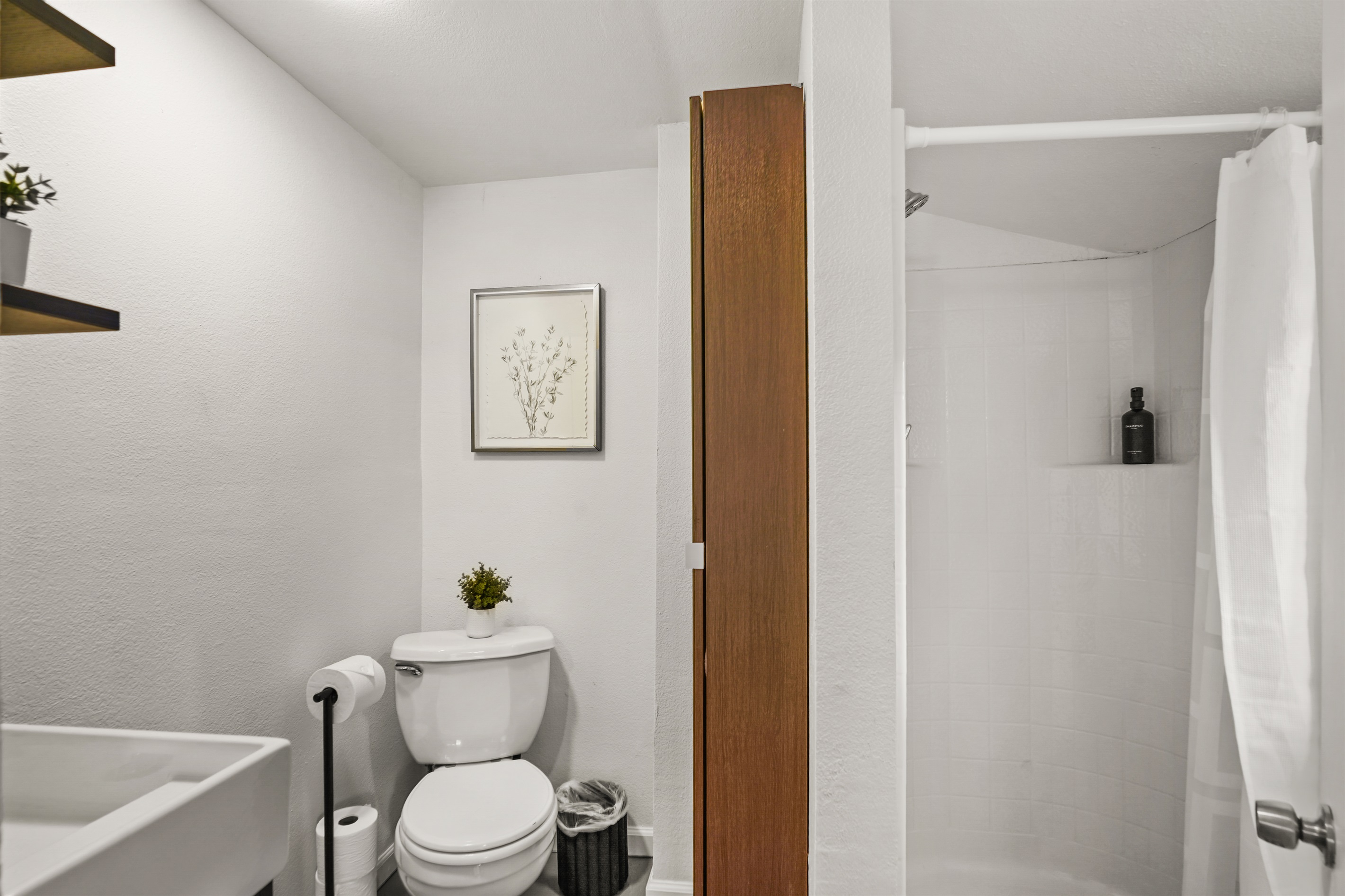 Fully renovated studio bathroom with modern finishes, a walk in shower, fresh towels, and a clean spa like feel.