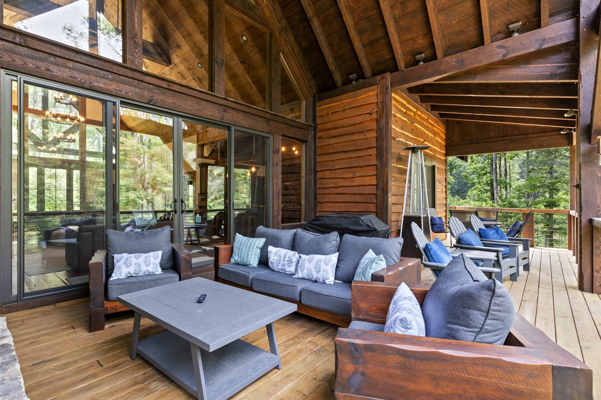 The spacious deck offers seating, a TV, and a cozy fireplace, making it a favorite spot to relax year-round.