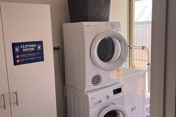 Laundry area with front loading washing machine & clothes dryer