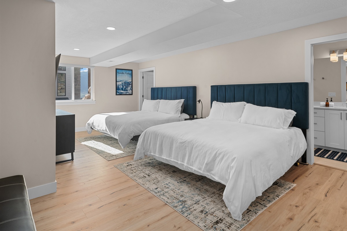 Lower-level ensuite bedroom with two king beds—perfect for groups.