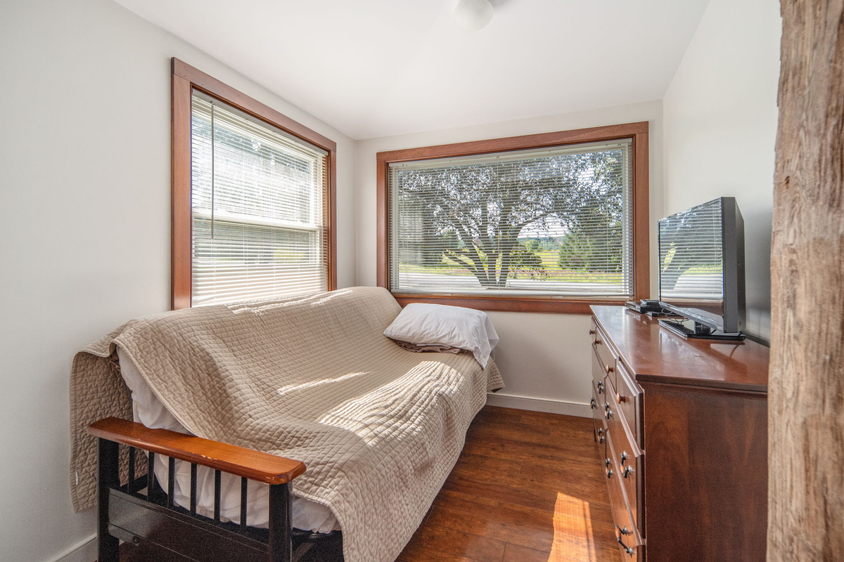 A comfortable futon and bedroom TV offer a spot to unwind