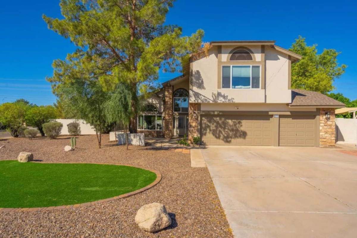 Spacious contemporary home with mature landscaping, desert-style grounds, and open floor plan.