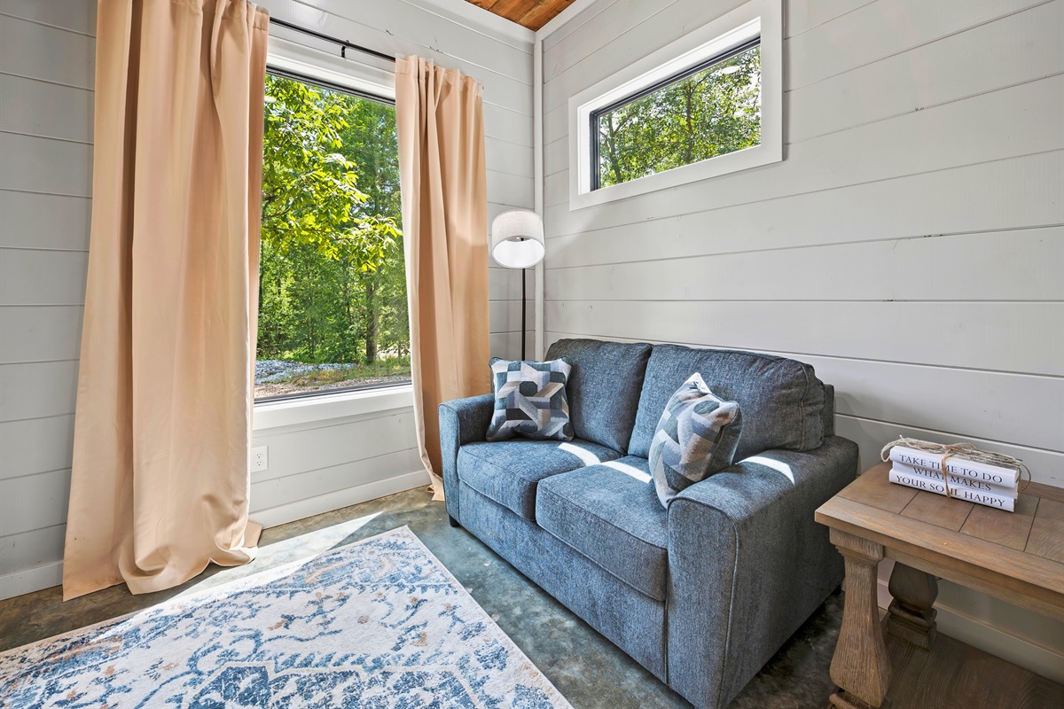 Sink into the cozy embrace of this charming nook, perfect for quiet afternoons with a book or peaceful morning contemplation.