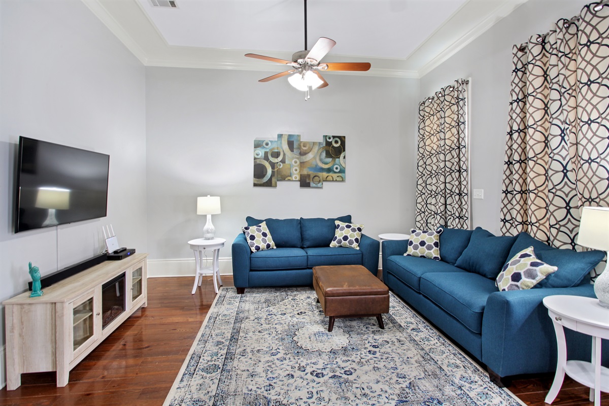 Living room.  Sleeper sofa. 55" cable smart tv. Electric fireplace. Curtains may be drawn for a more private sleeping area.