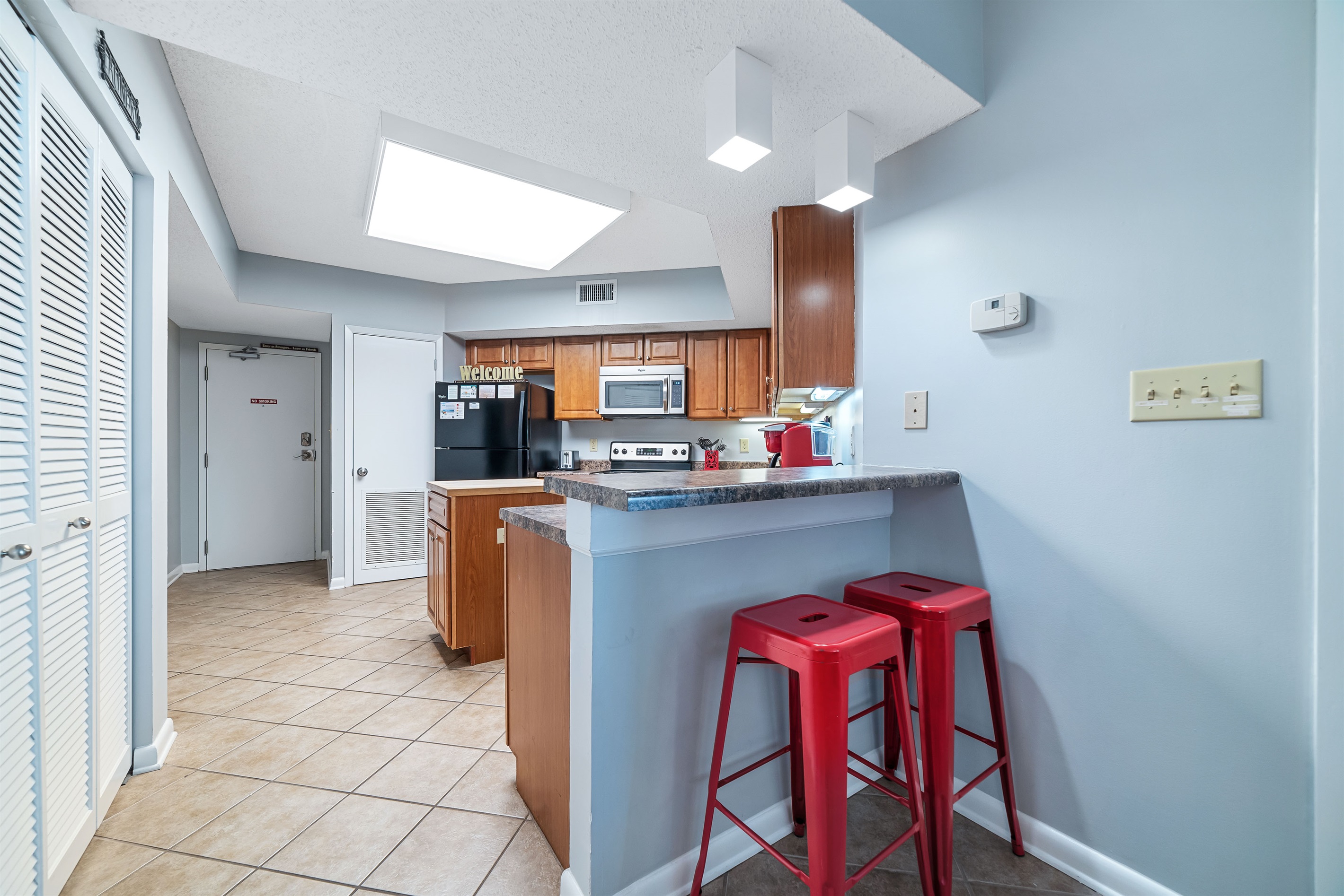 A touch of texture and warmth in this modern kitchen, with a unique brick-clad island providing character and charm.