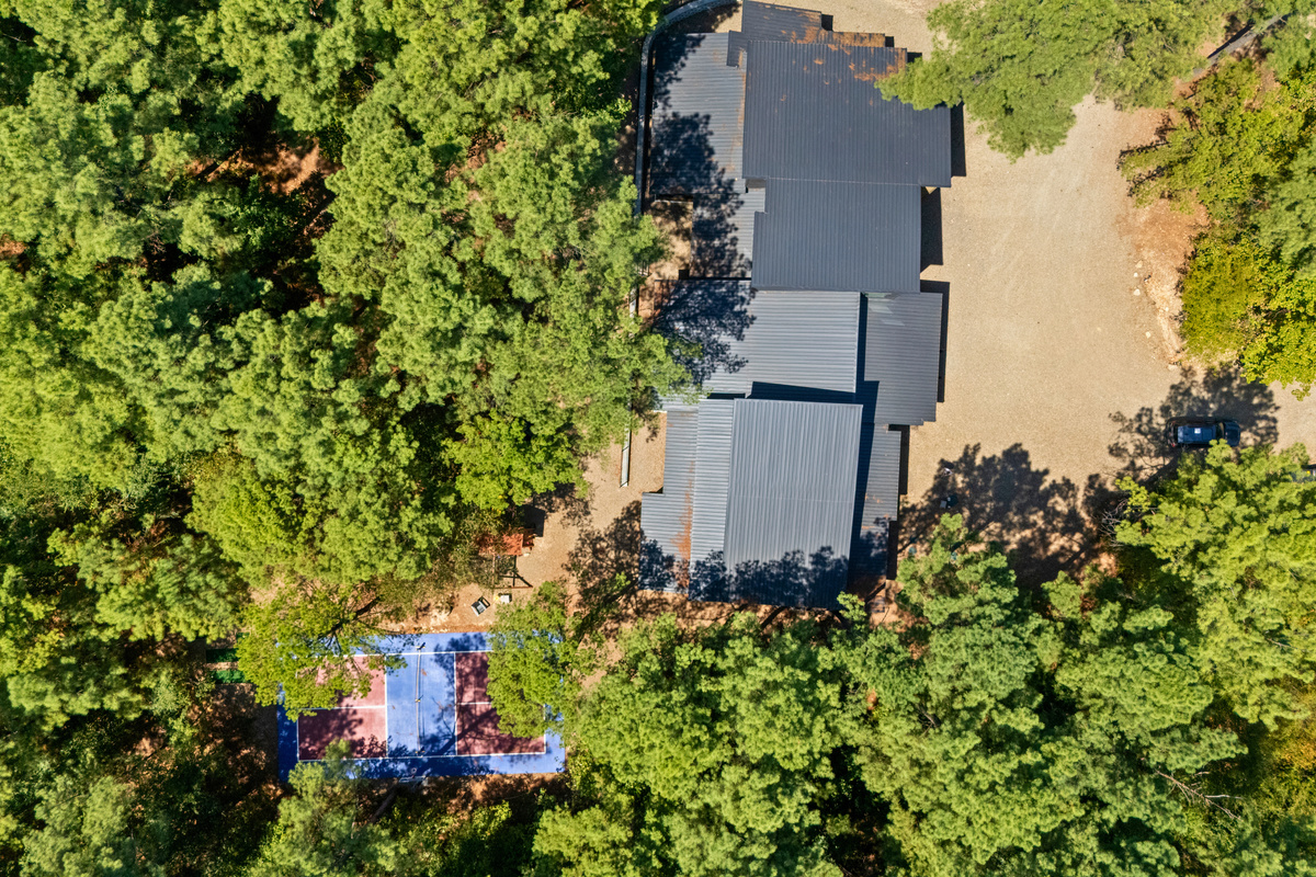 From above, you can see just how tucked away the cabin feels among the trees, offering a private wooded setting with plenty of outdoor space to enjoy.