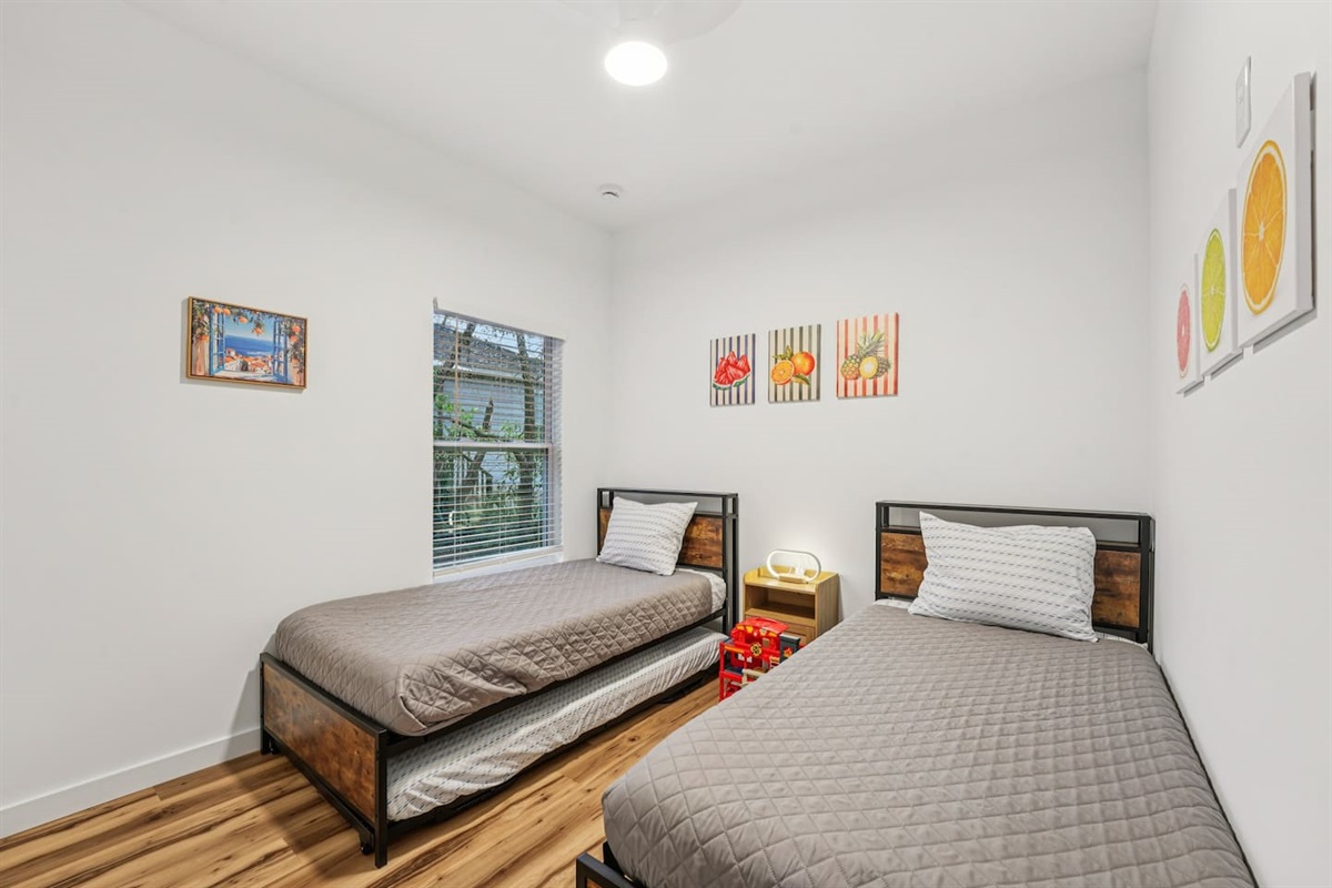 Third bedroom has 2 twin beds, with a 3rd twin bed trundle under the left bed with extra blanket and pillow in the closet.