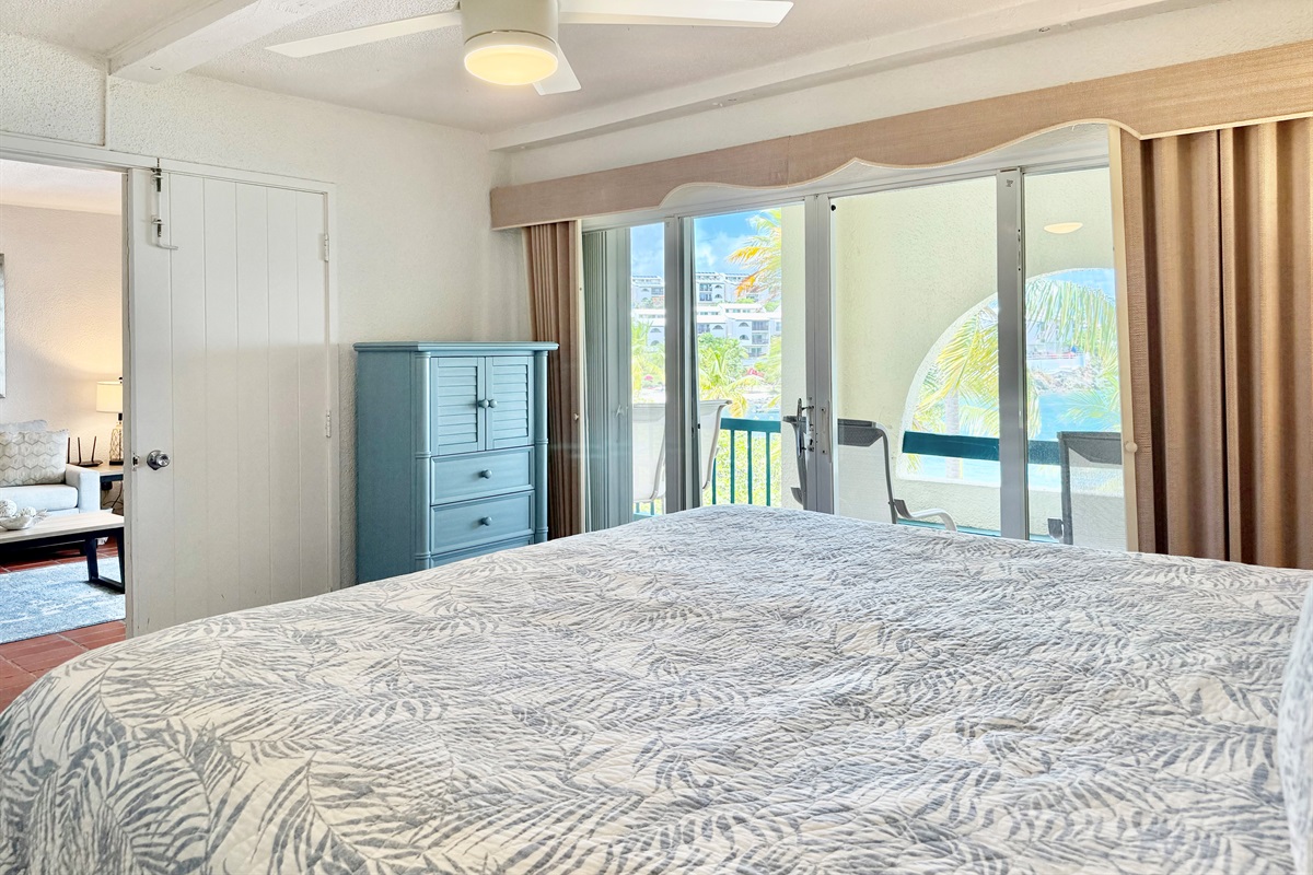 Primary bedroom with king bed, ensuite bathroom and balcony access