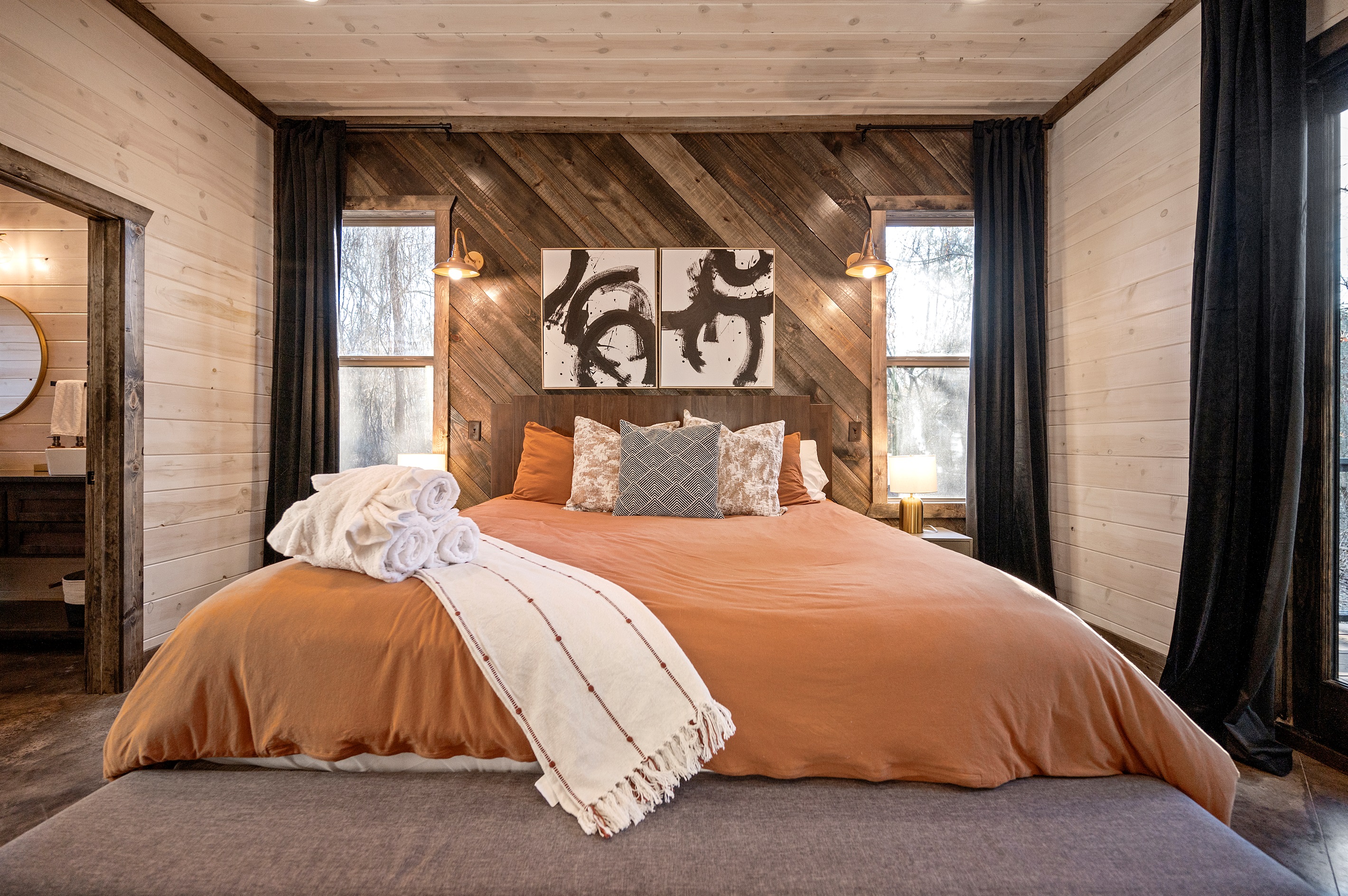 Relax in this inviting woodland suite with rich textures, abstract art, and peaceful natural light.