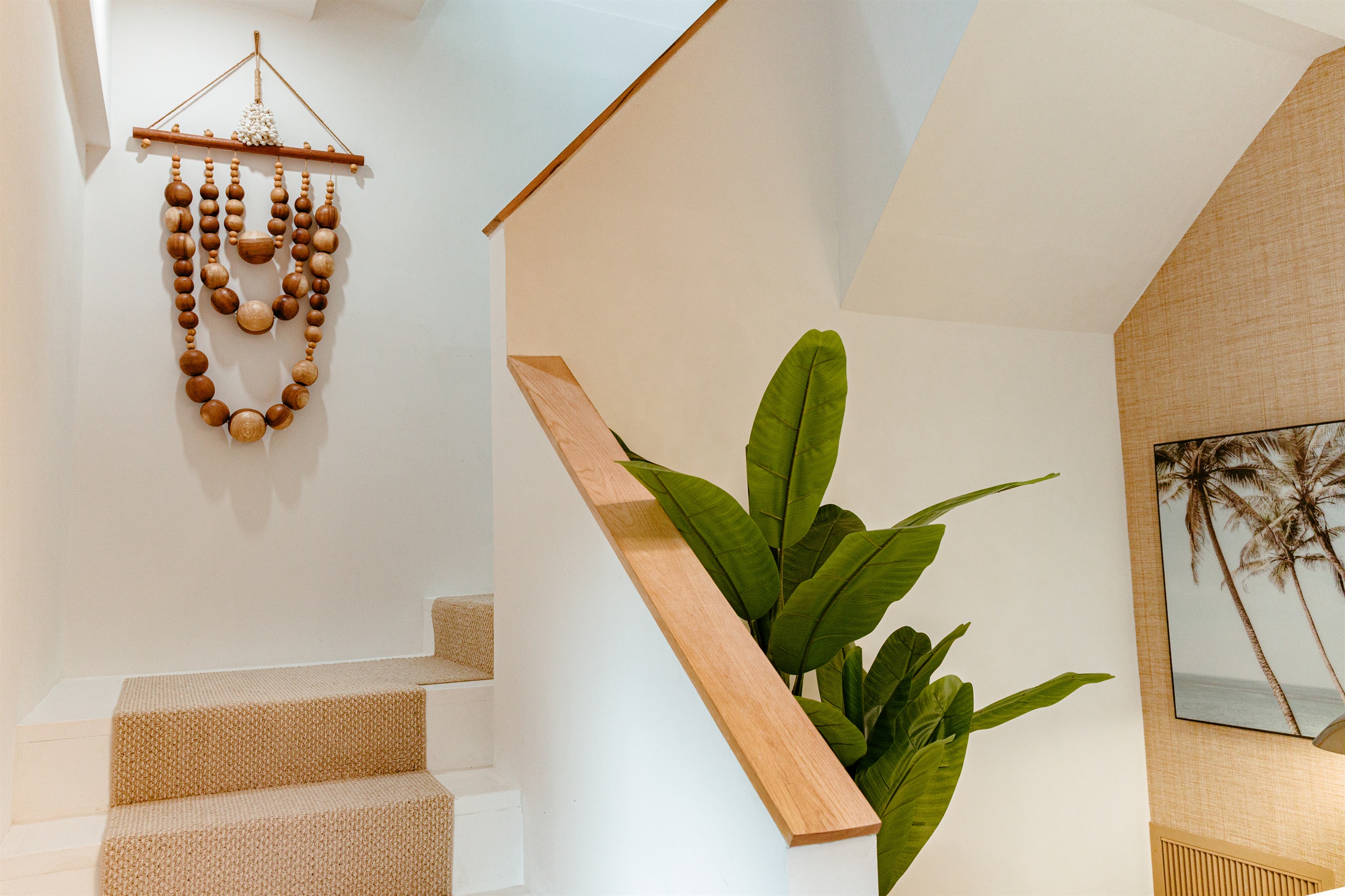 As you enter the cottage, you're greeted with an accent wall that highlights Palm Beach vibes.