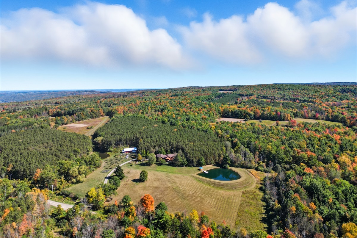 Escape to your own private retreat surrounded by rolling hills and forest. This stunning property features a spring-fed pond with a dock, wide-open meadows, and total privacy—perfect for relax
