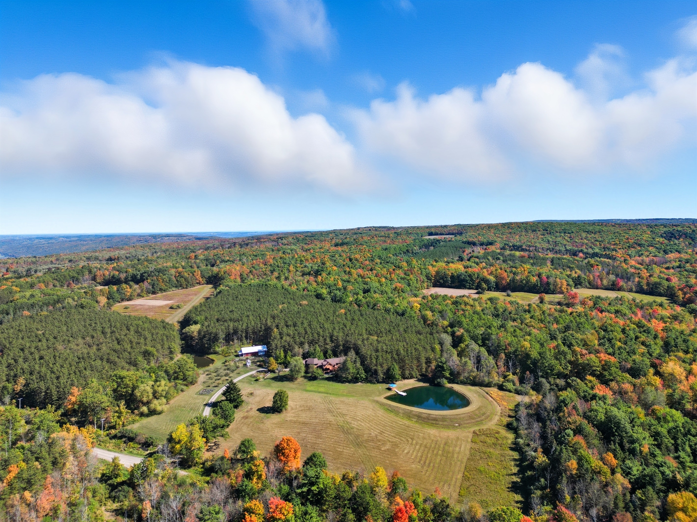 Escape to your own private retreat surrounded by rolling hills and forest. This stunning property features a spring-fed pond with a dock, wide-open meadows, and total privacy—perfect for relax