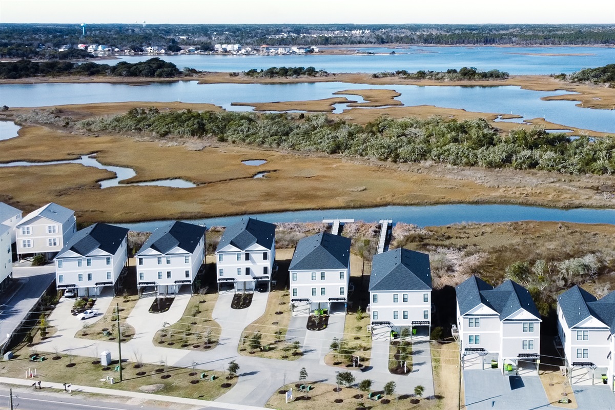 A serene backdrop of open water, grasses, and coastal nature