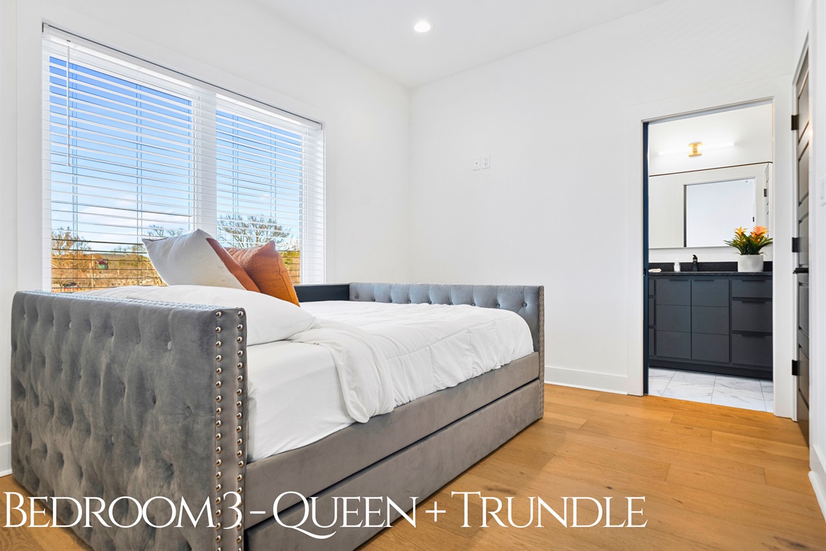 This serene queen bedroom with a pull-out trundle offers both style and flexibility, making it a perfect option for families or groups.