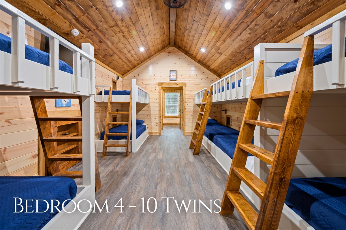 The upstairs bunk room is designed with groups in mind, featuring multiple built-in bunks that make it perfect for kids, cousins, or friends staying together.