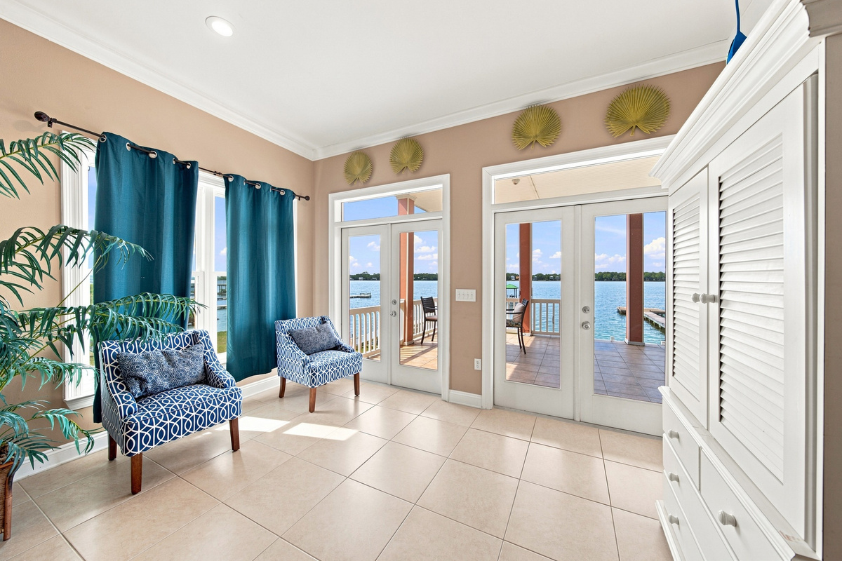 Open living room with coastal accents and water-view windows