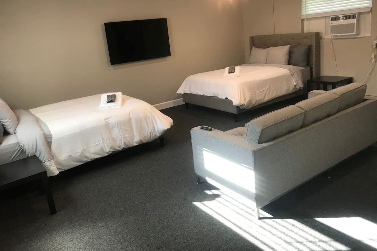 Two queen beds with couch, and a 58inch smart TV in the Bonus Room.