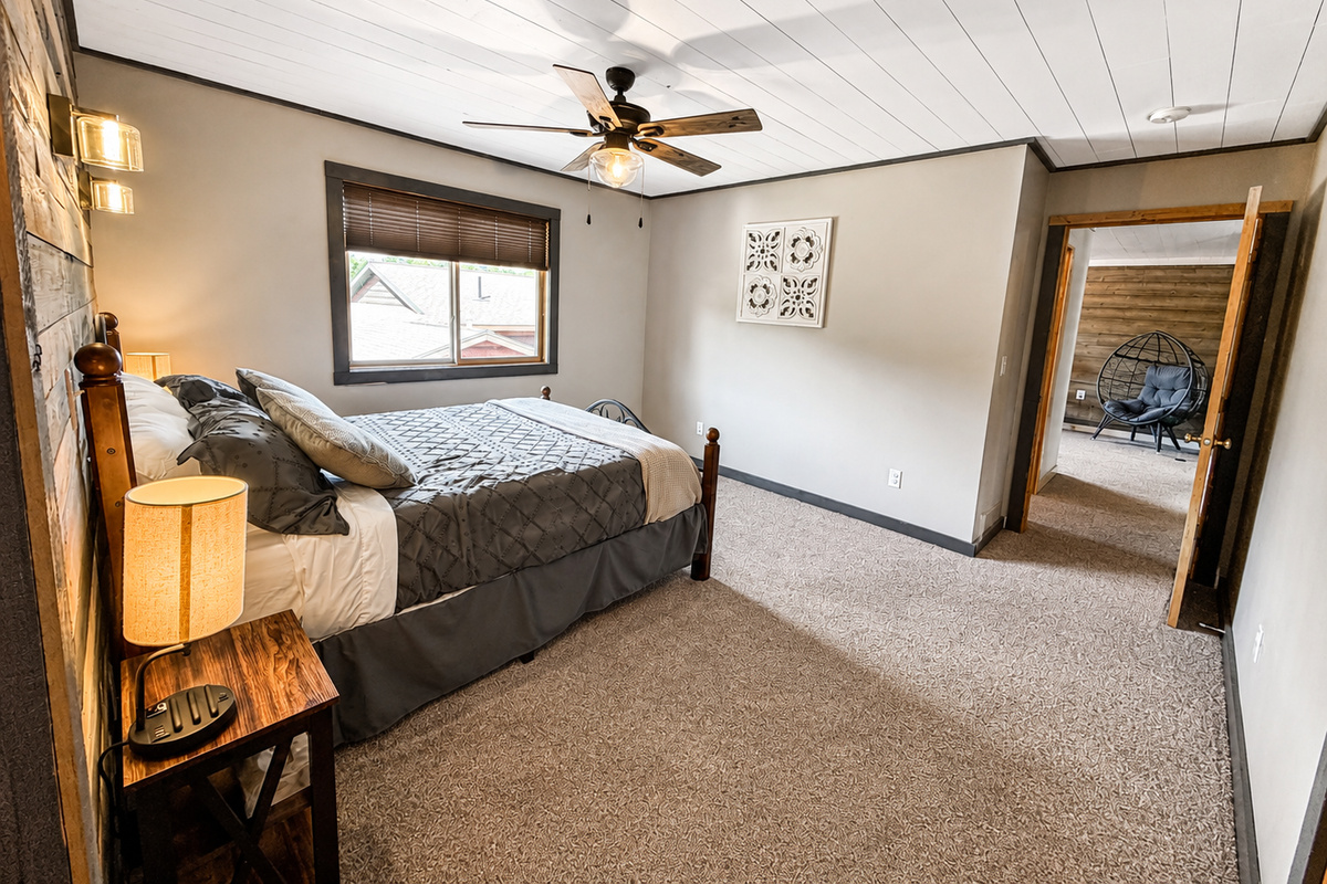 Another angle of the guest bedroom highlights the roomy layout and comfortable sleeping space.