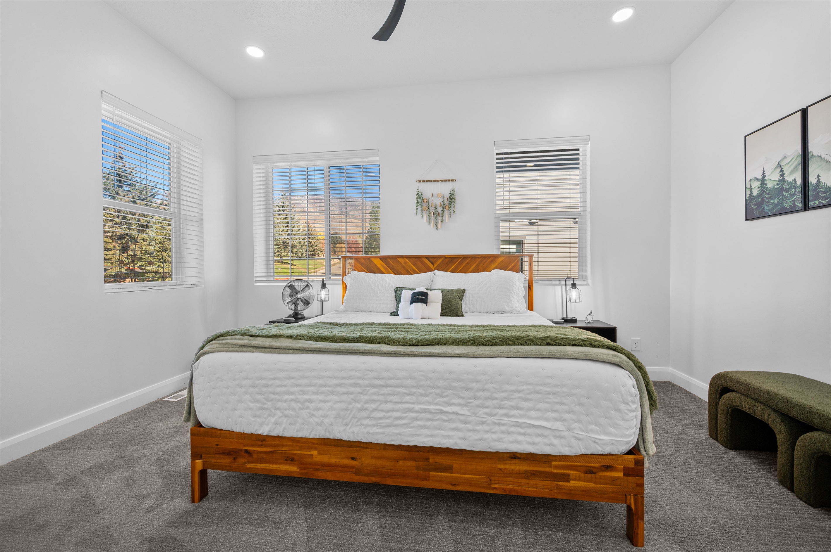 Primary bedroom featuring a king bed, ceiling fan, and stunning views