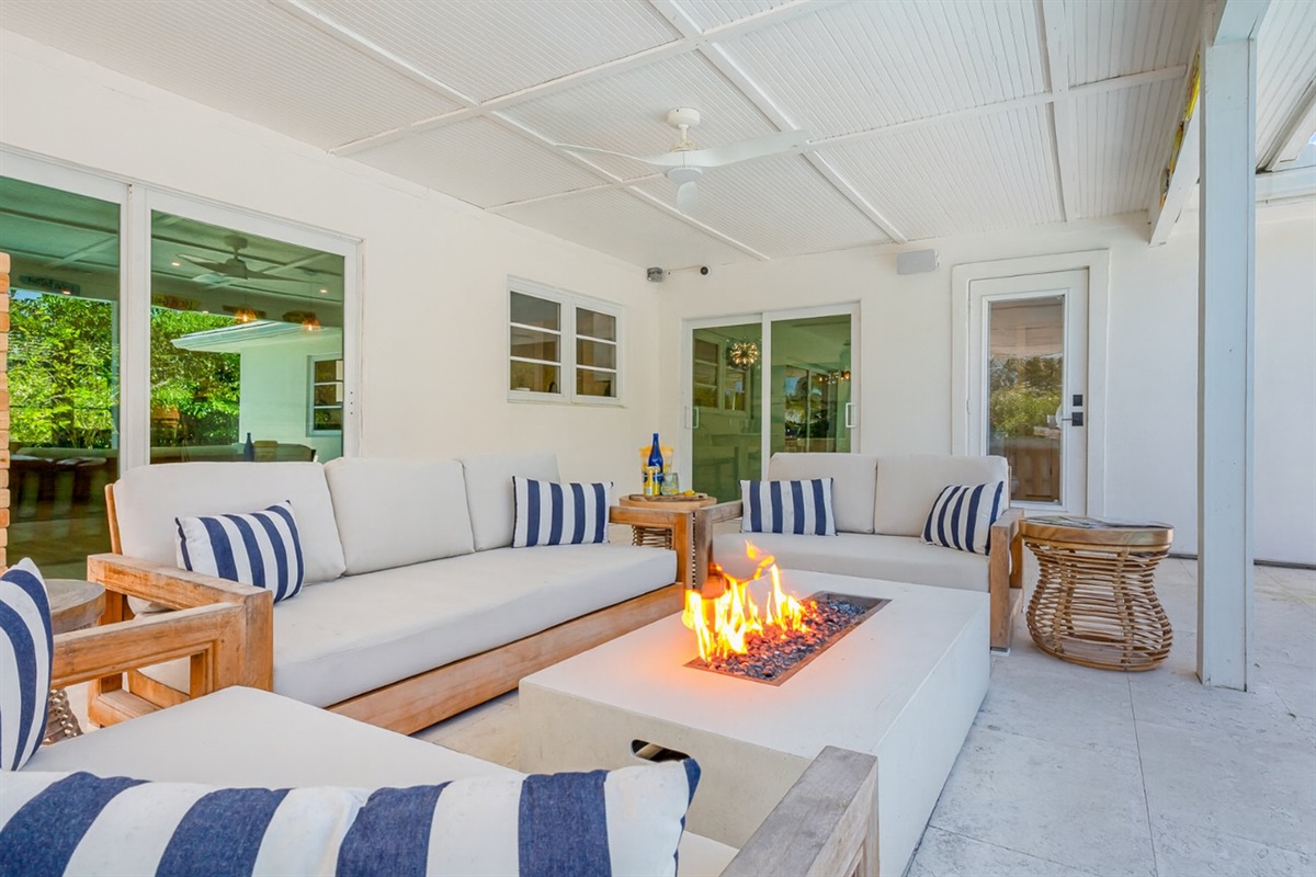 The pool deck is finished in shell white limestone, offering a beautiful natural backdrop.  By night, enjoy the tiki bar, TV, fire table, and the glow of the Jupiter Lighthouse Beacon 