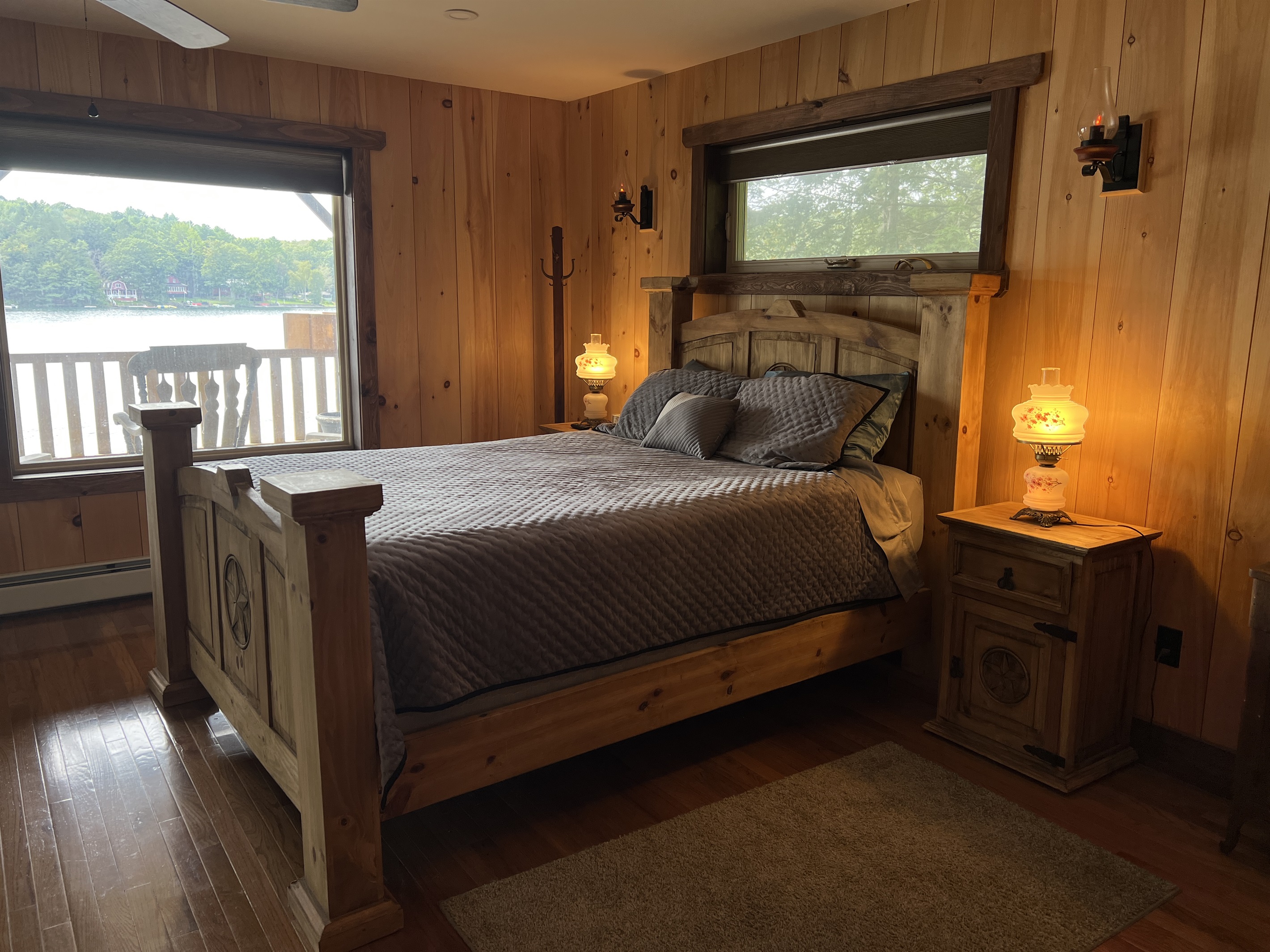 Primary bedroom with deck over looking water