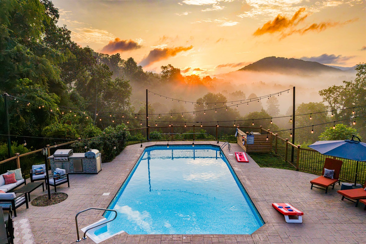 Your own private resort experience, complete with glowing string lights, lounge seating, and a sparkling pool set against the morning sky. The sunrises are simply worth waking up a bit early to enjoy this, right outside your window or off the balcony.