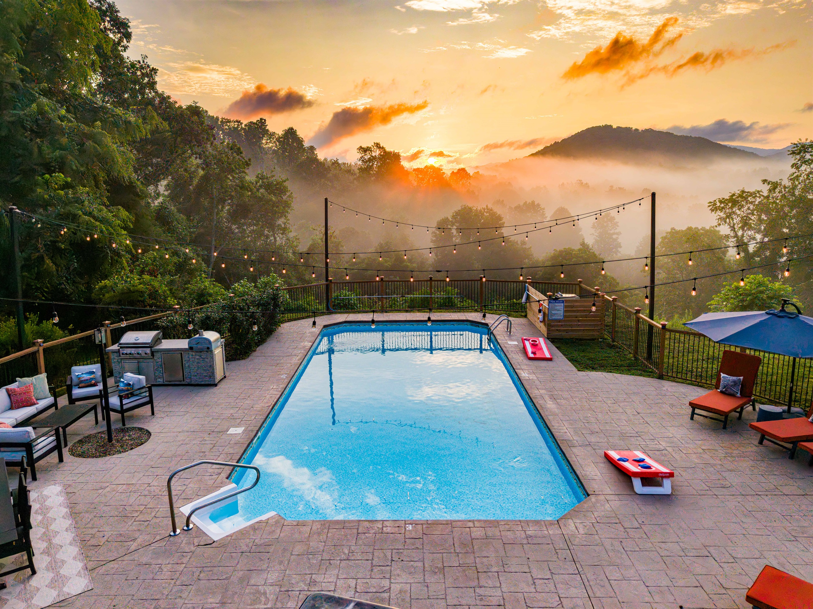 Your own private resort experience, complete with glowing string lights, lounge seating, and a sparkling pool set against the morning sky. The sunrises are simply worth waking up a bit early to enjoy this, right outside your window or off the balcony.