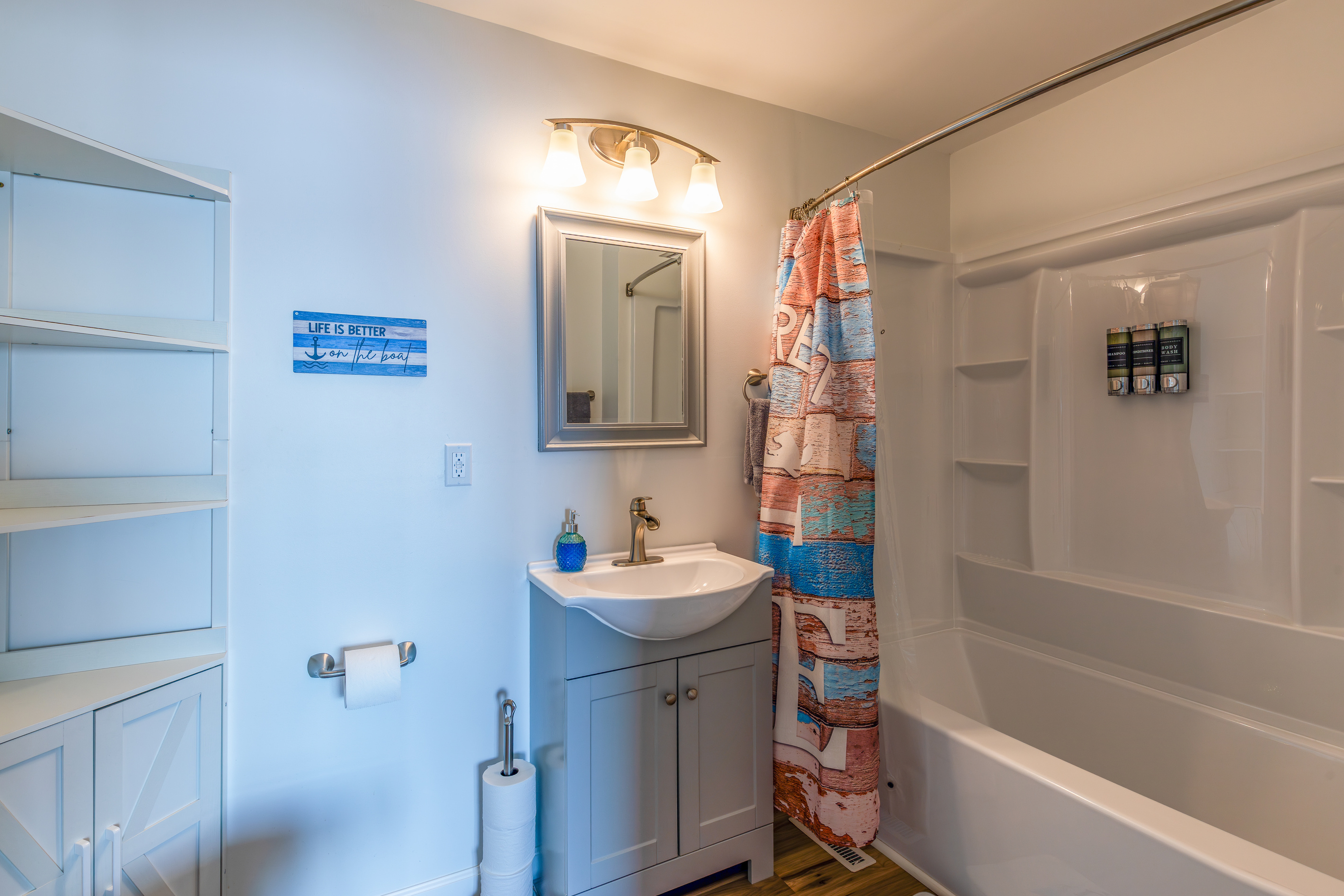 The upstairs private bathroom includes a full tub-shower combination, sink, and built-in storage.